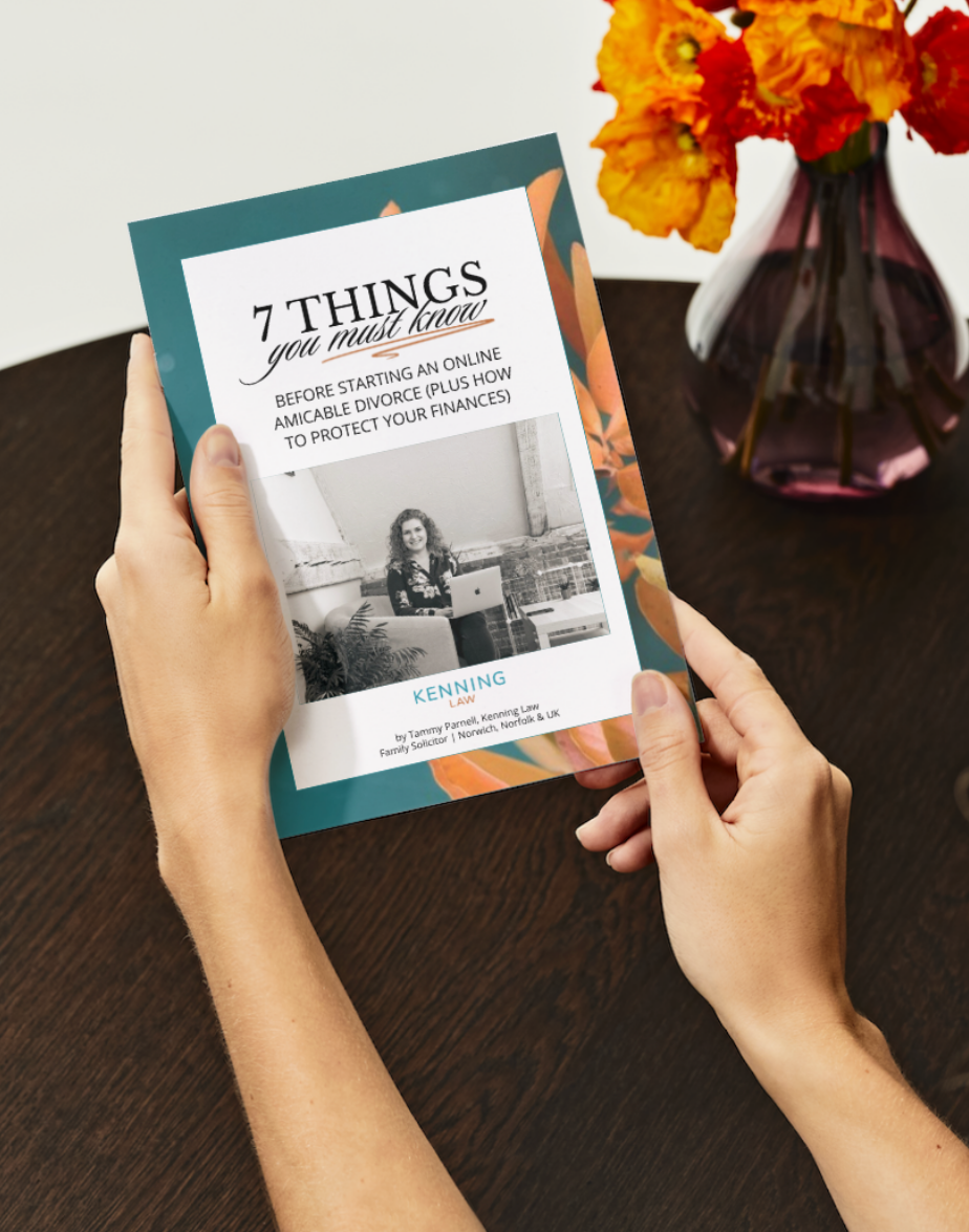 lady holding an amicable online divorce free guide created by Kenning Law in Norfolk, With orange plants in background